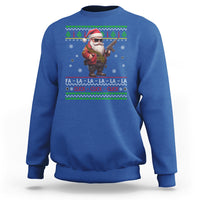 Royal blue Christmas sweatshirt with Santa holding toy gun and festive text graphic