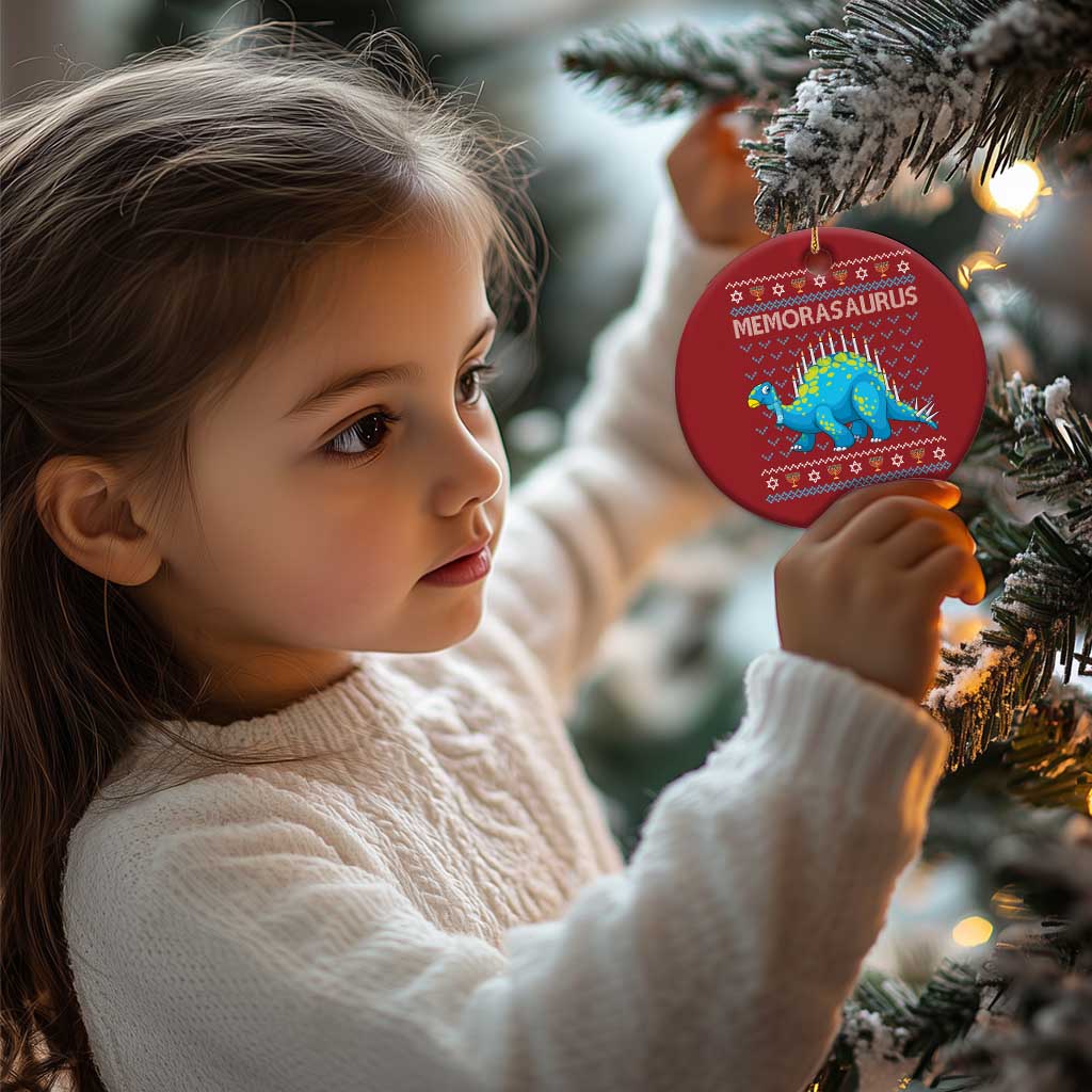 Red Menorasaurus dinosaur ornament with menorah candles, held by a child