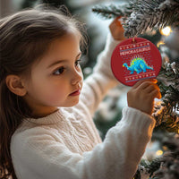 Red Menorasaurus dinosaur ornament with menorah candles, held by a child