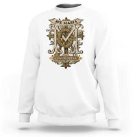 White crewneck sweatshirt with gold "Ave Maria" and "Gratia Plena" crest graphic