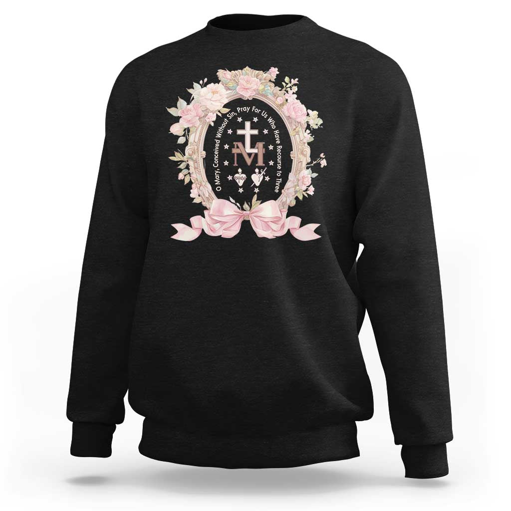 Black crewneck sweatshirt with floral Miraculous Medal graphic on chest