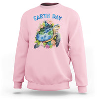Light pink Earth Day sweatshirt with sea turtle graphic and flowers on the chest