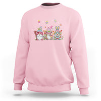 Light pink crewneck sweatshirt with colorful Easter gnome and egg hunt graphic on chest.