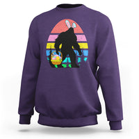 Purple crewneck sweatshirt with Bigfoot bunny Easter egg graphic on the front