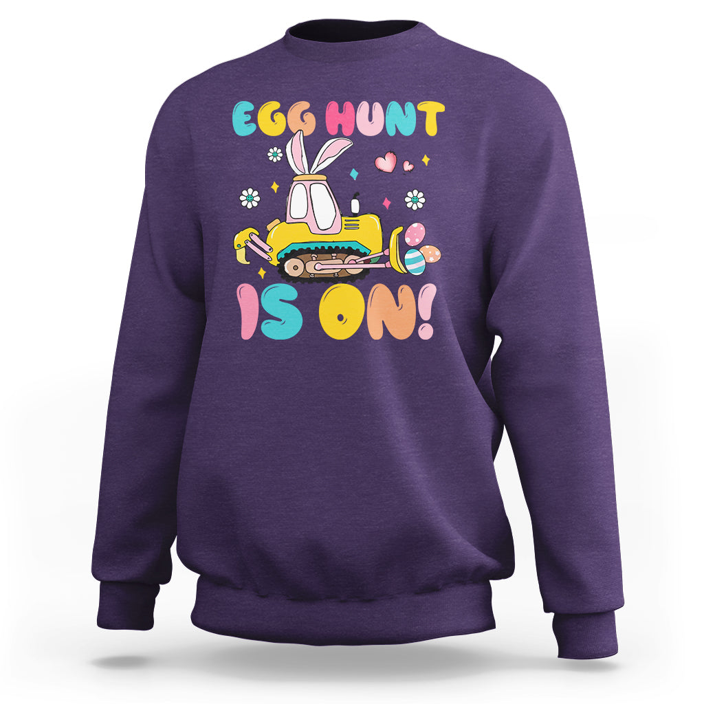 Purple Easter egg hunt sweatshirt with bunny tractor graphic and colorful text