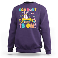 Purple Easter egg hunt sweatshirt with bunny tractor graphic and colorful text