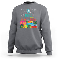 Gray crewneck sweatshirt with “Hello” graphic and multicolor globe print on front.