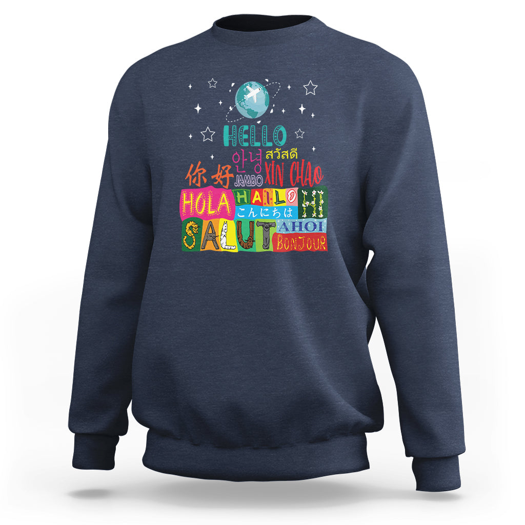 Navy blue crewneck sweatshirt with “Hello” graphic and multicolor globe print on front.