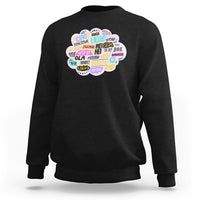 Black sweatshirt with multicolor circular “hello” greetings graphic on the chest