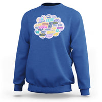 Royal blue sweatshirt with multicolor circular “hello” greetings graphic on the chest