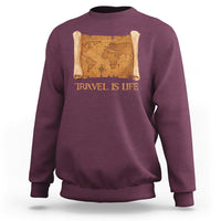 Maroon crewneck sweatshirt with vintage world map scroll graphic and “Travel is Life” text