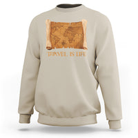 Sand crewneck sweatshirt with vintage world map scroll graphic and “Travel is Life” text