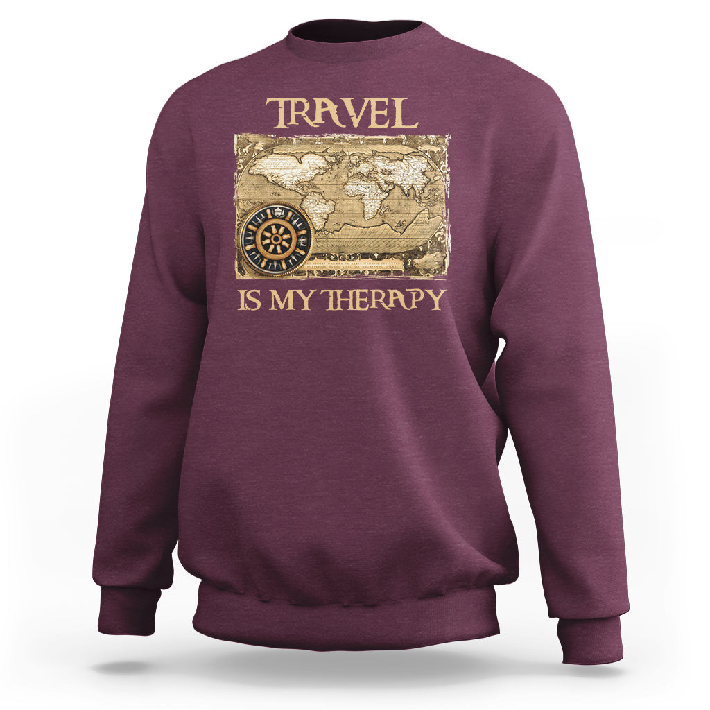 Maroon travel-themed sweatshirt with vintage world map and compass graphic, front view