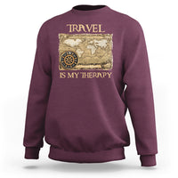 Maroon travel-themed sweatshirt with vintage world map and compass graphic, front view