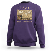 Purple travel-themed sweatshirt with vintage world map and compass graphic, front view