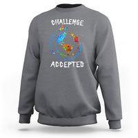 Charcoal crewneck sweatshirt with globe graphic and "CHALLENGE ACCEPTED" print