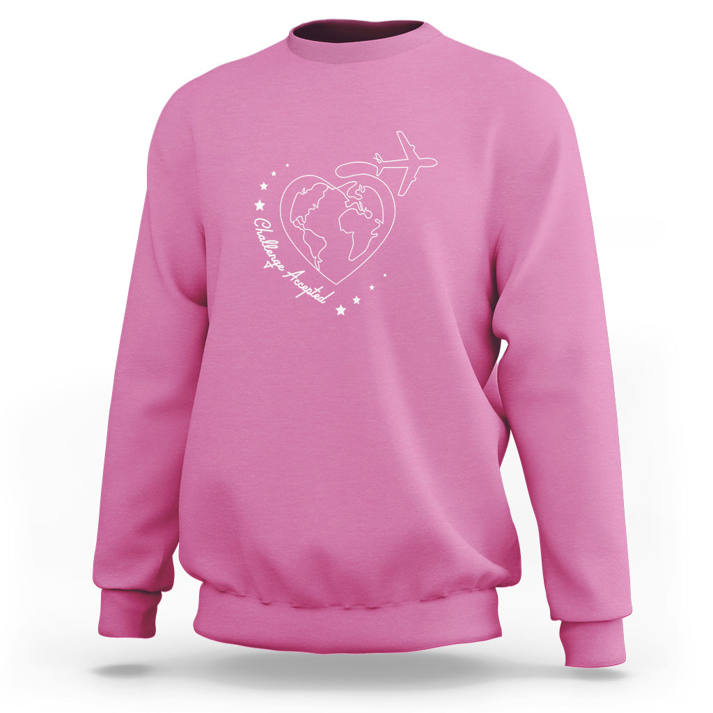 Azalea pink crewneck sweatshirt with white globe, airplane, and heart graphic on chest