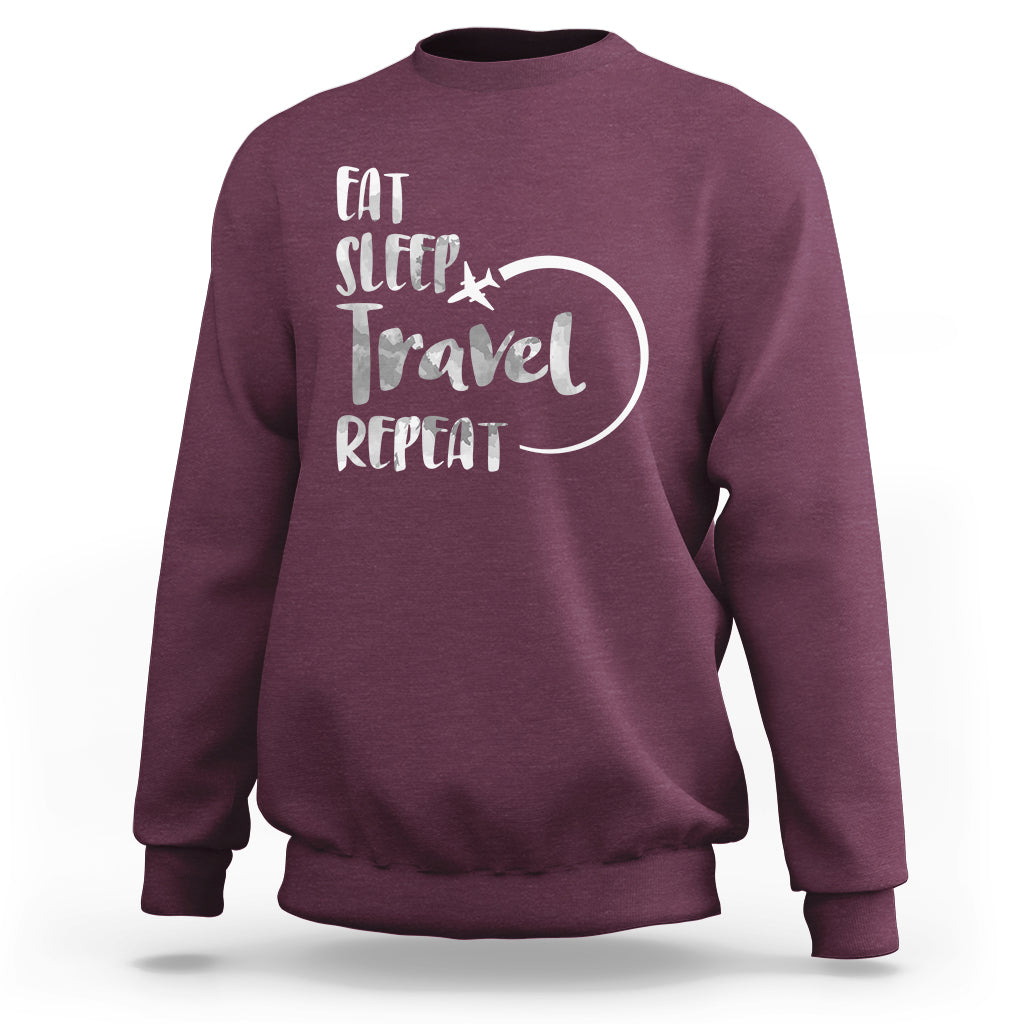Maroon crewneck sweatshirt with 'Eat Sleep Travel Repeat' graphic on back.