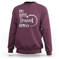 Maroon crewneck sweatshirt with 'Eat Sleep Travel Repeat' graphic on back.