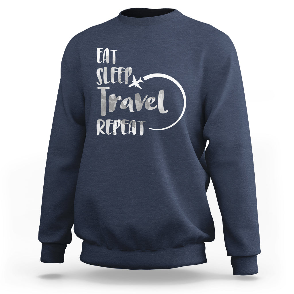 Navy crewneck sweatshirt with 'Eat Sleep Travel Repeat' graphic on back.
