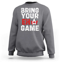 Charcoal gray sweatshirt with “Bring Your Eh Game” Canada flag and maple leaf graphic