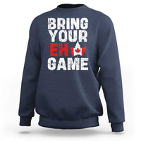 Navy sweatshirt with “Bring Your Eh Game” Canada flag and maple leaf graphic