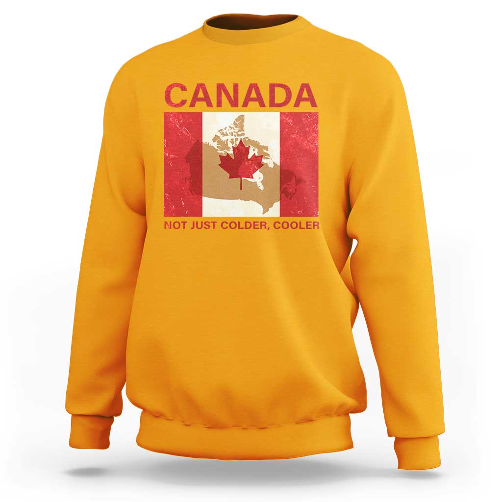 Gold crewneck sweatshirt with “CANADA” graphic and “NOT JUST COLDER, COOLER” text
