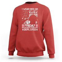 Red crewneck sweatshirt with patriotic “Friday” graphic on front