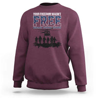 Maroon crewneck sweatshirt with front “Free” graphic and deployed memorial text