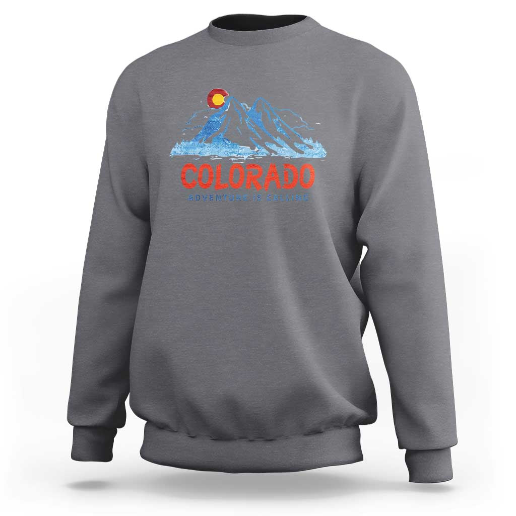 Gray crewneck sweatshirt with Colorado mountain graphic and 'Adventure Is Calling' print