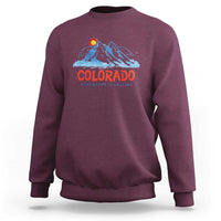 Maroon crewneck sweatshirt with Colorado mountain graphic and 'Adventure Is Calling' print