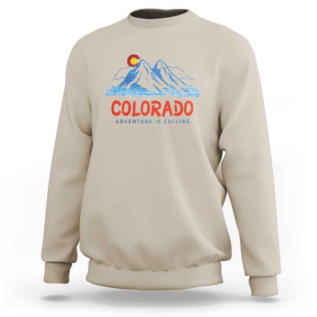 Beige crewneck sweatshirt with Colorado mountain graphic and 'Adventure Is Calling' print