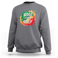 Gray crewneck sweatshirt with colorful “Good Vibes Only” rasta graphic on front