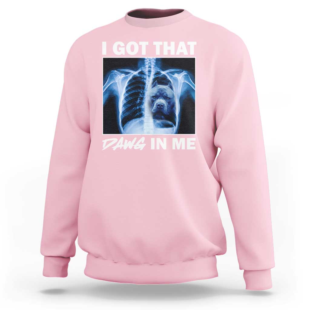 Men's light pink sweatshirt with blue x-ray pitbull graphic and "DAWG IN ME" text