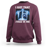 Men's maroon sweatshirt with blue x-ray pitbull graphic and "DAWG IN ME" text