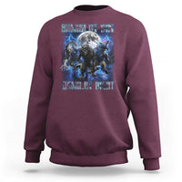 Maroon crewneck sweatshirt with wolf graphic and moon text, long sleeves