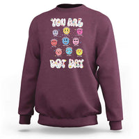 Maroon crewneck sweatshirt with colorful dot-face graphic and 'YOU ARE DOT DAY' print.