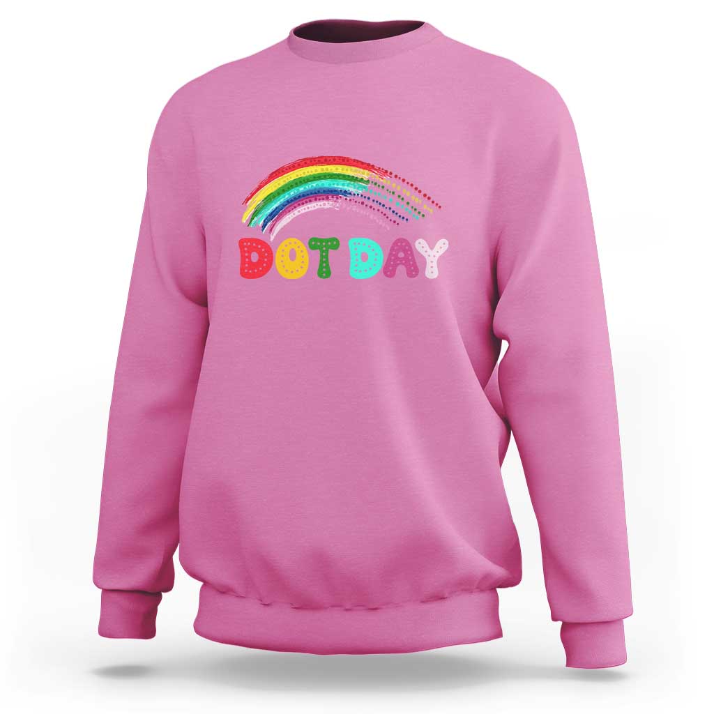 Pink sweatshirt with rainbow arch and “DOT DAY” graphic on the chest