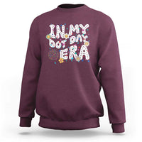 Maroon crewneck sweatshirt with colorful 'Happy Dot Day' graphic front