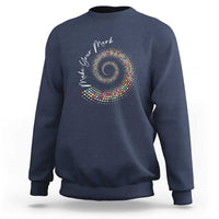 Navy sweatshirt with colorful dot spiral graphic on chest
