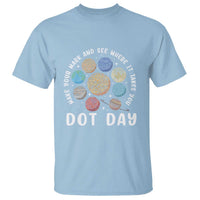 Light blue Dot Day graphic T-shirt with colorful planet dot print and “DOT DAY” text
