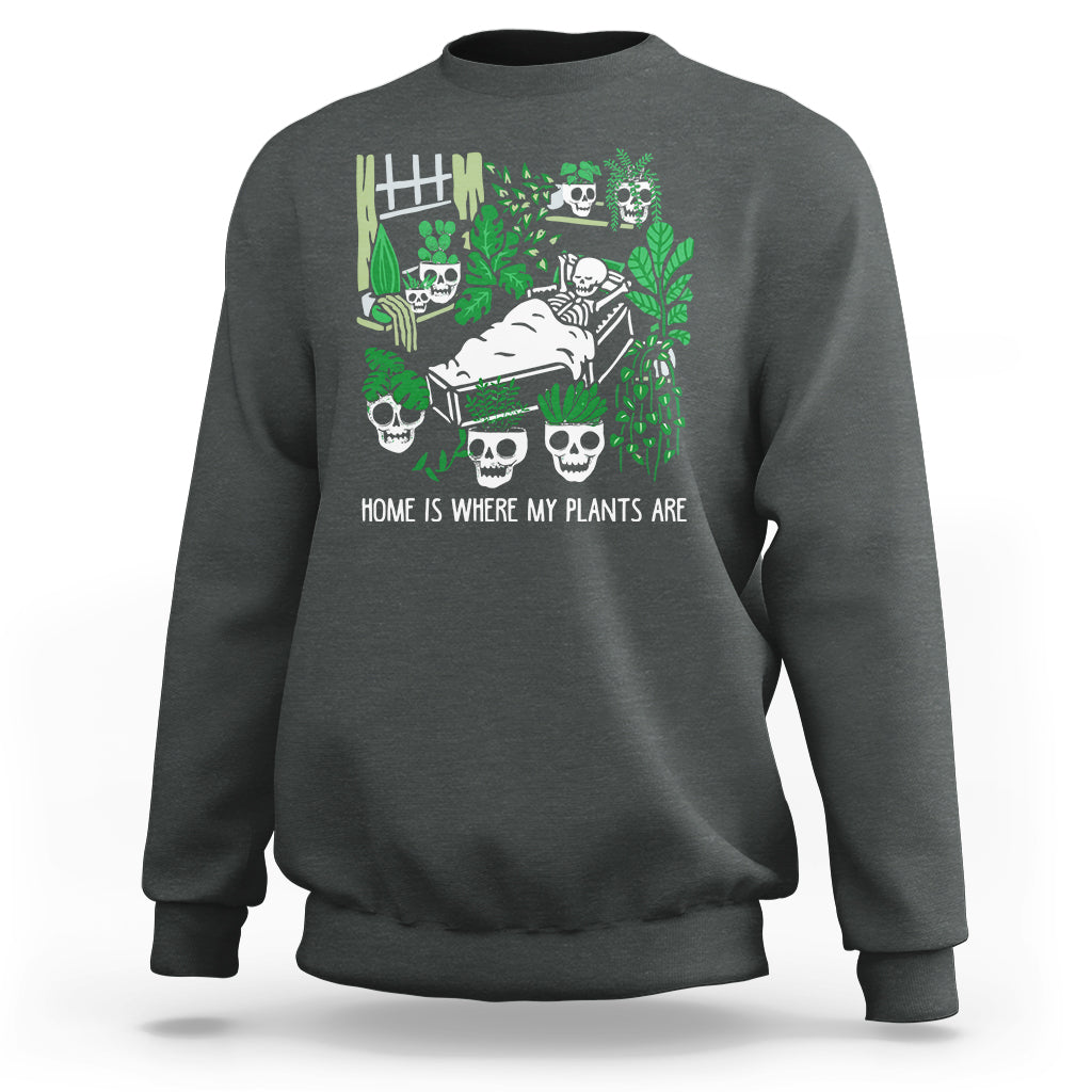 Dark heather gray crewneck sweatshirt with green skull-and-plant graphic on front