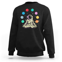 Black sweatshirt with astronaut meditating graphic and colorful solar system planets print