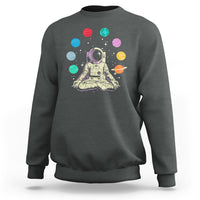 Dark heather gray sweatshirt with astronaut meditating graphic and colorful solar system planets print