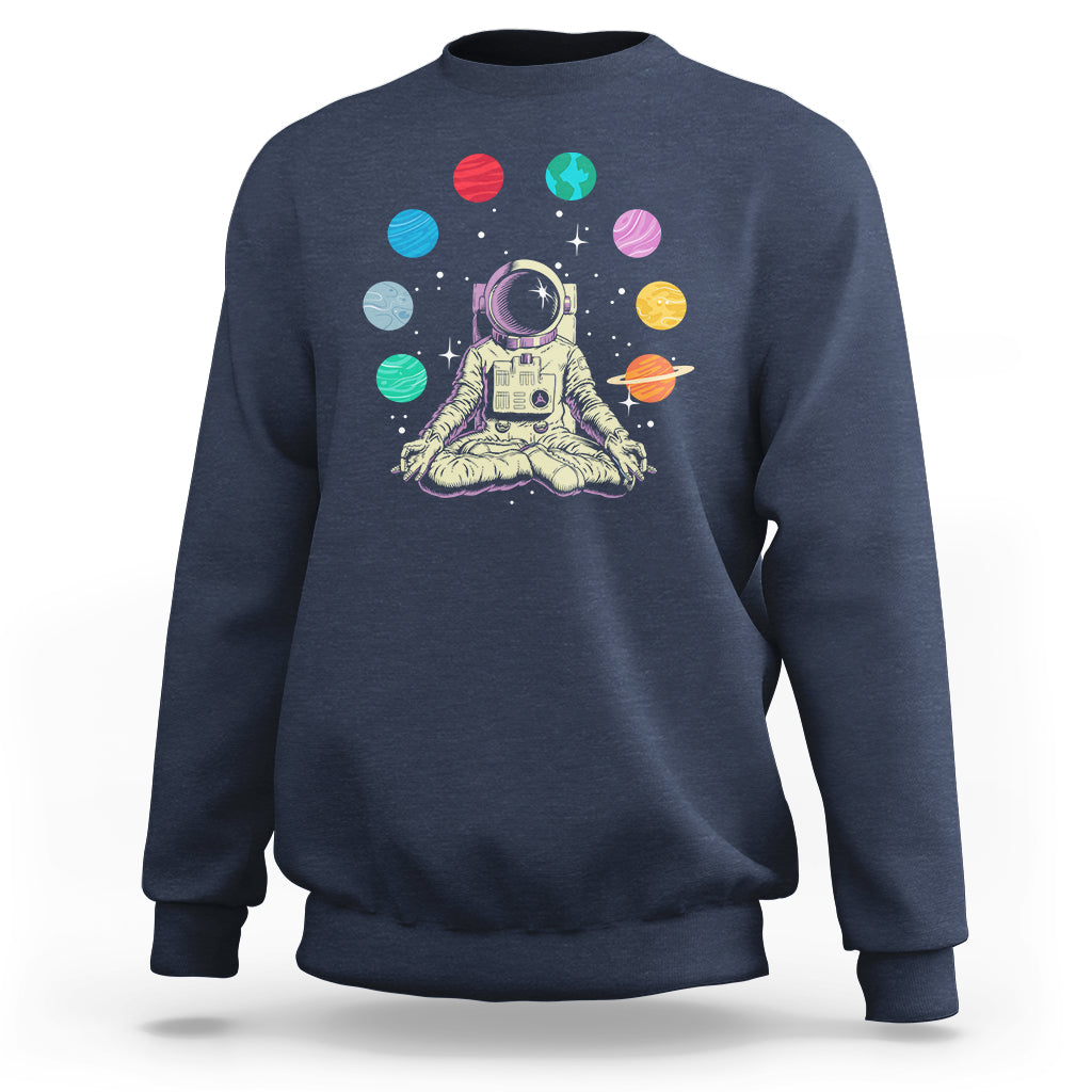 Navy sweatshirt with astronaut meditating graphic and colorful solar system planets print
