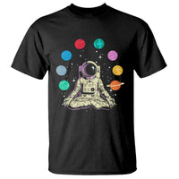 Black t-shirt with astronaut meditating graphic and colorful planets print