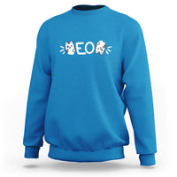 Sapphire blue sweatshirt with cat “EO” graphic, crew neck, long sleeves.