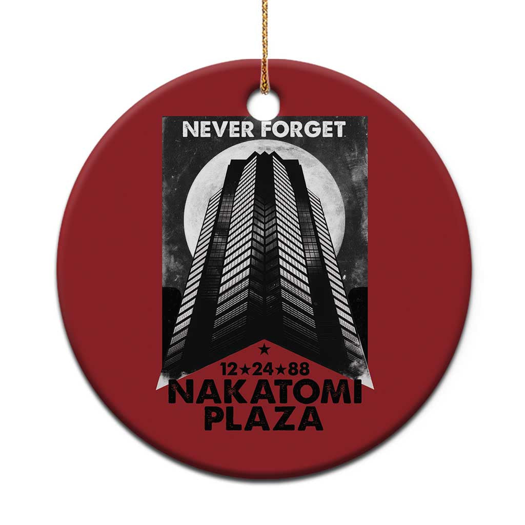 Red round Christmas ornament with building graphic and “Never Forget Nakatomi Plaza”