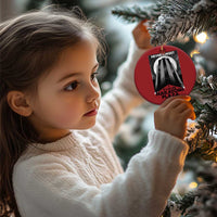 Red round Christmas ornament with building graphic and “Never Forget Nakatomi Plaza”