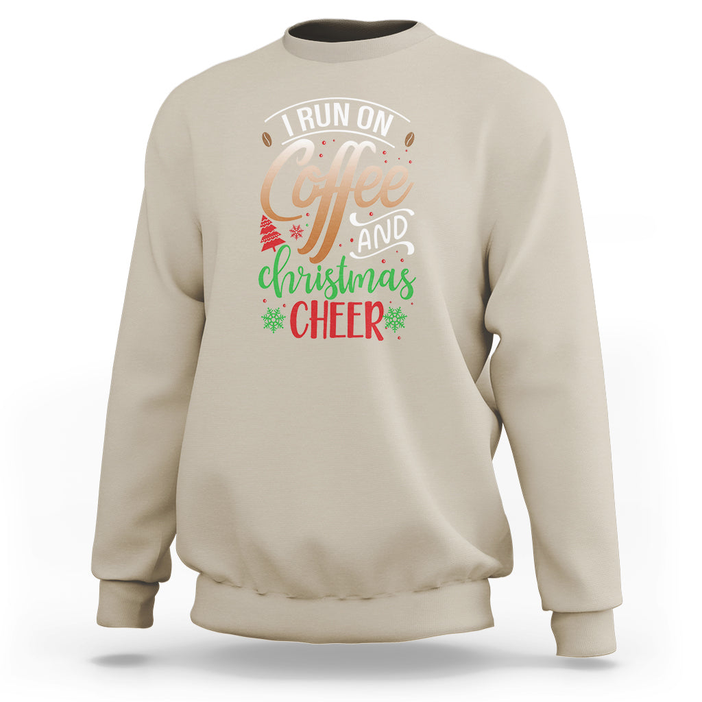 Sand color sweatshirt with "I Run On Coffee" and "Christmas Cheer" graphic on chest